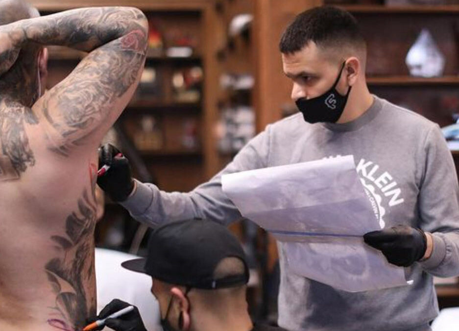 Image of Tattoo artist Frank Sanchez sketching out a tattoo
