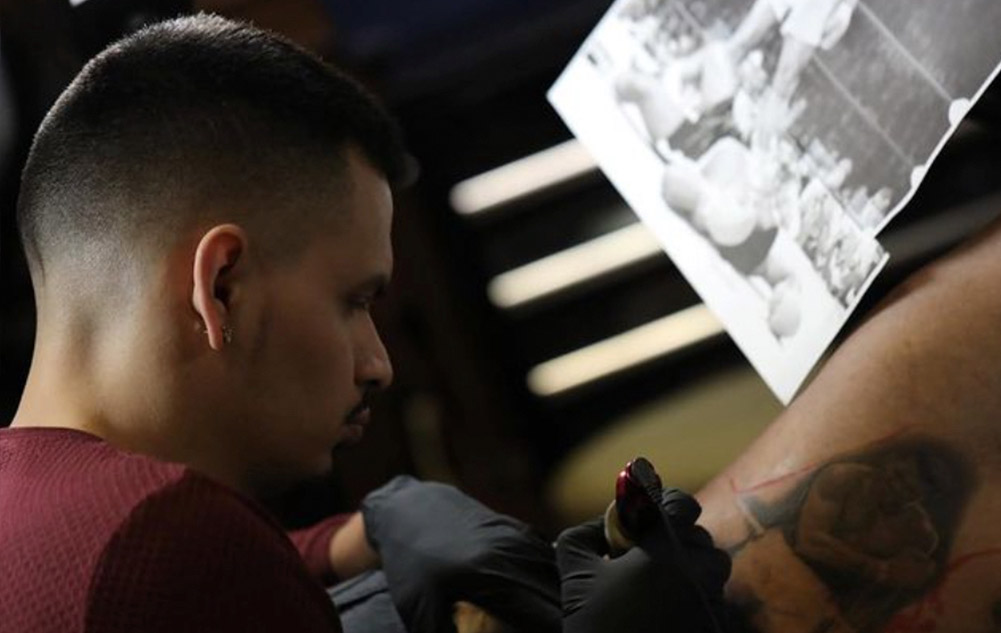 Francisco Sanchez working on a custom portrait tattoo design